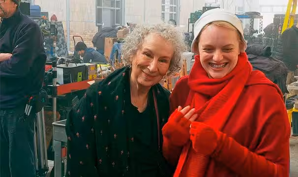 Atwood with leading lady Elisabeth Moss on the set of the Handmaids